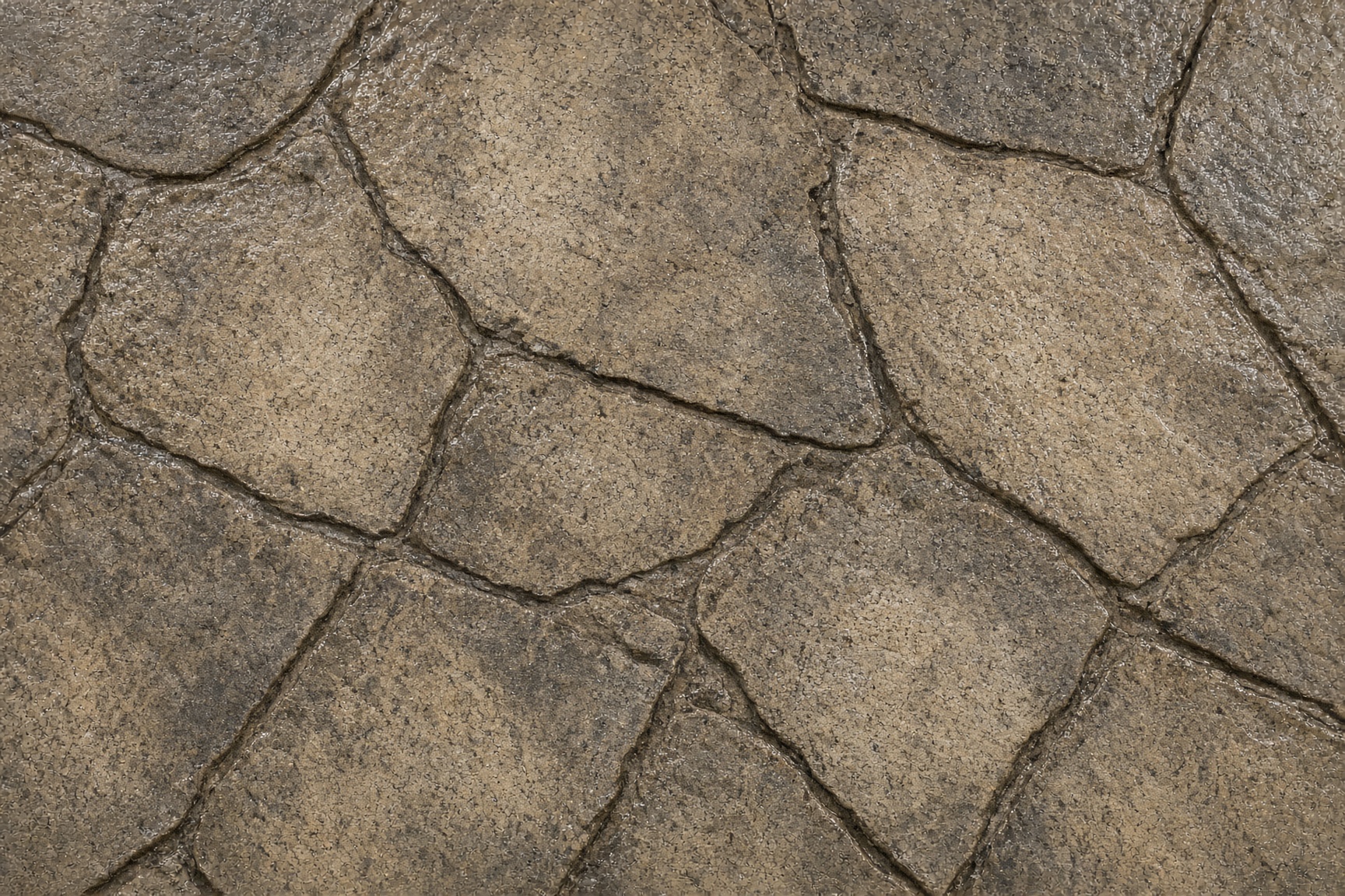 Close-up of stamped flagstone concrete with taupe, sand, and charcoal color and a sealed finish